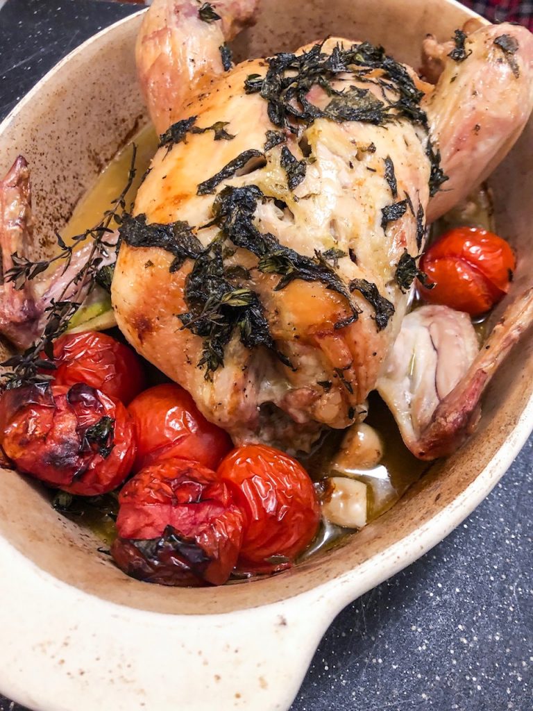 Roast chicken with basil, thyme, tomatoes and garlic