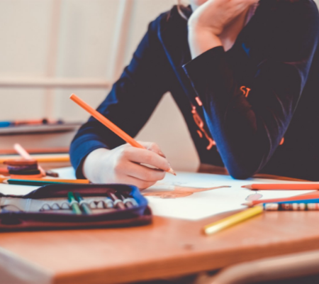 woman holding pencil at her desk